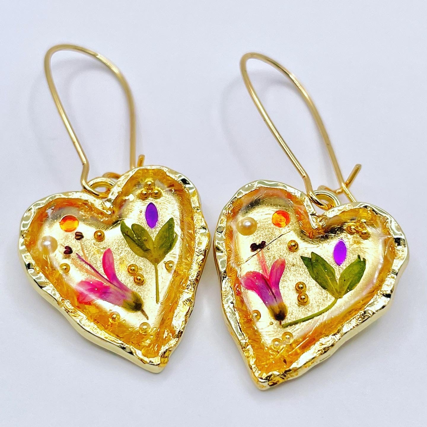 Gold heart earrings with pink flowers