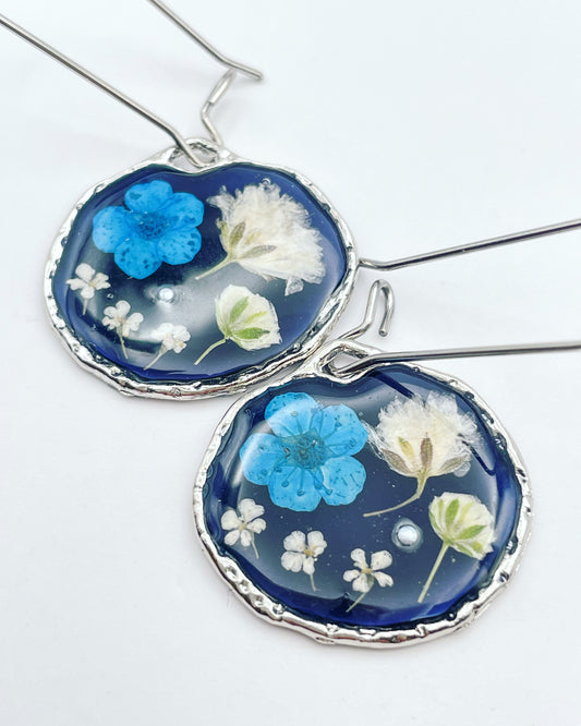 Black dangle earrings with blue and white flowers