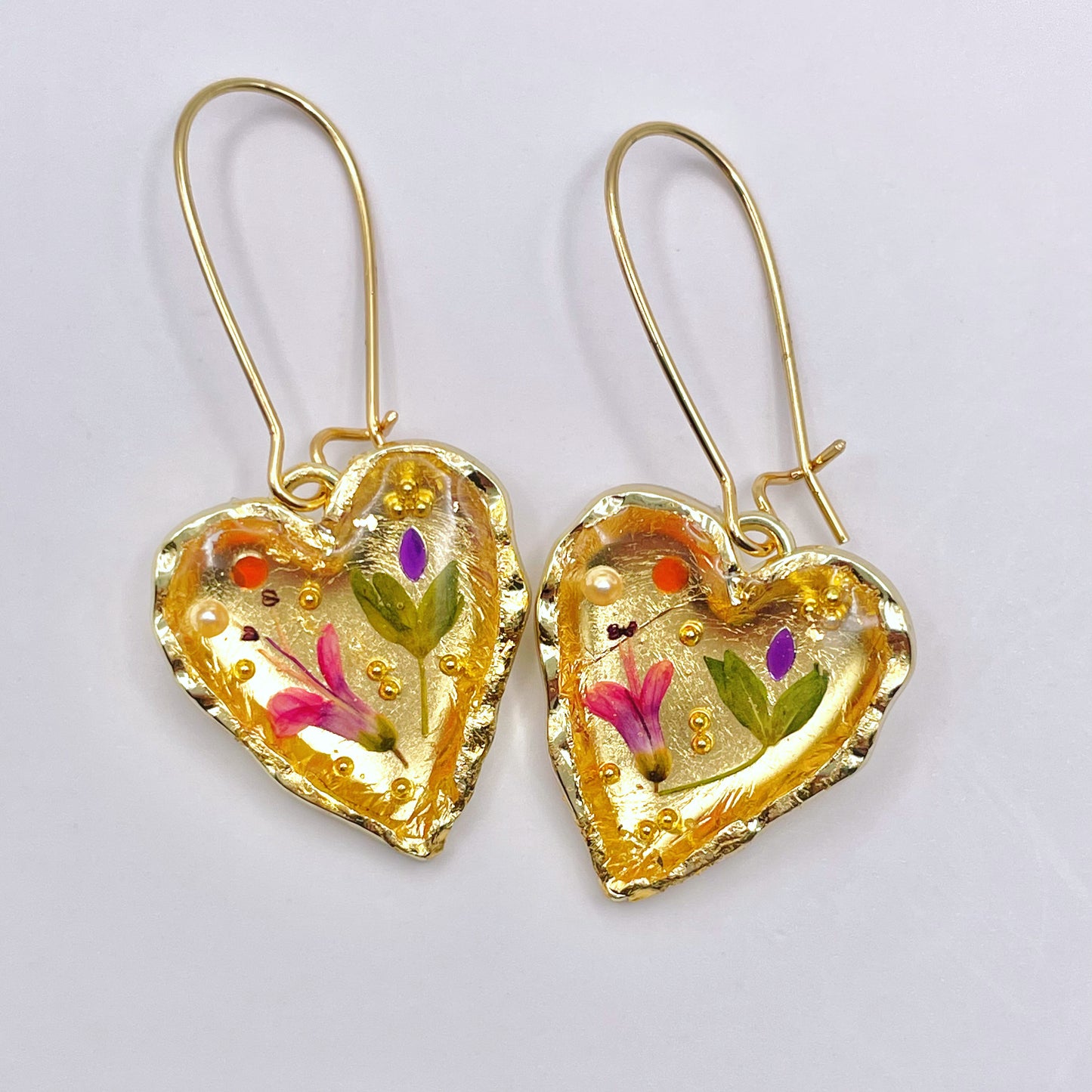 Gold heart earrings with pink flowers