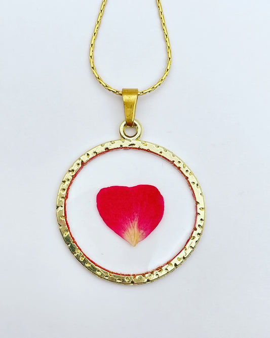 Gold pendant with red rose petals