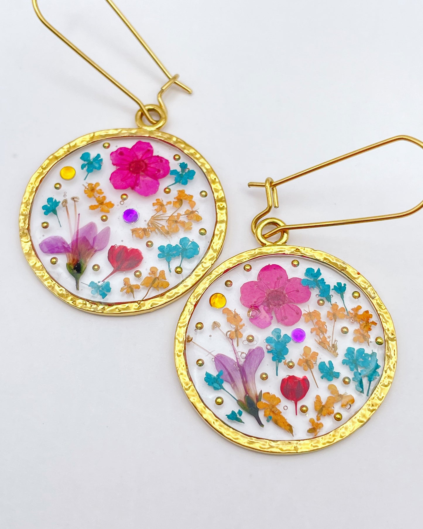 Statement earrings with pink flowers in gold