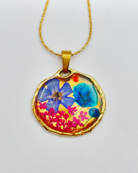 Gold pendant necklace with pink and blue flowers