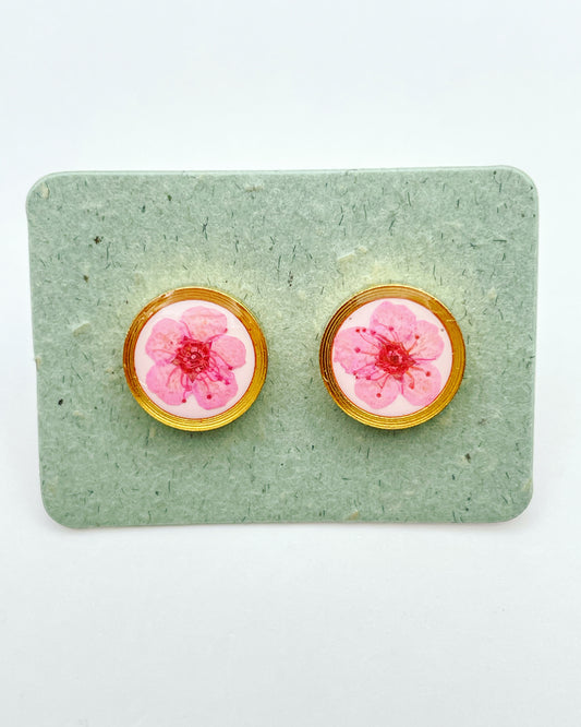 Stud earrings with pink flowers in white lacquer