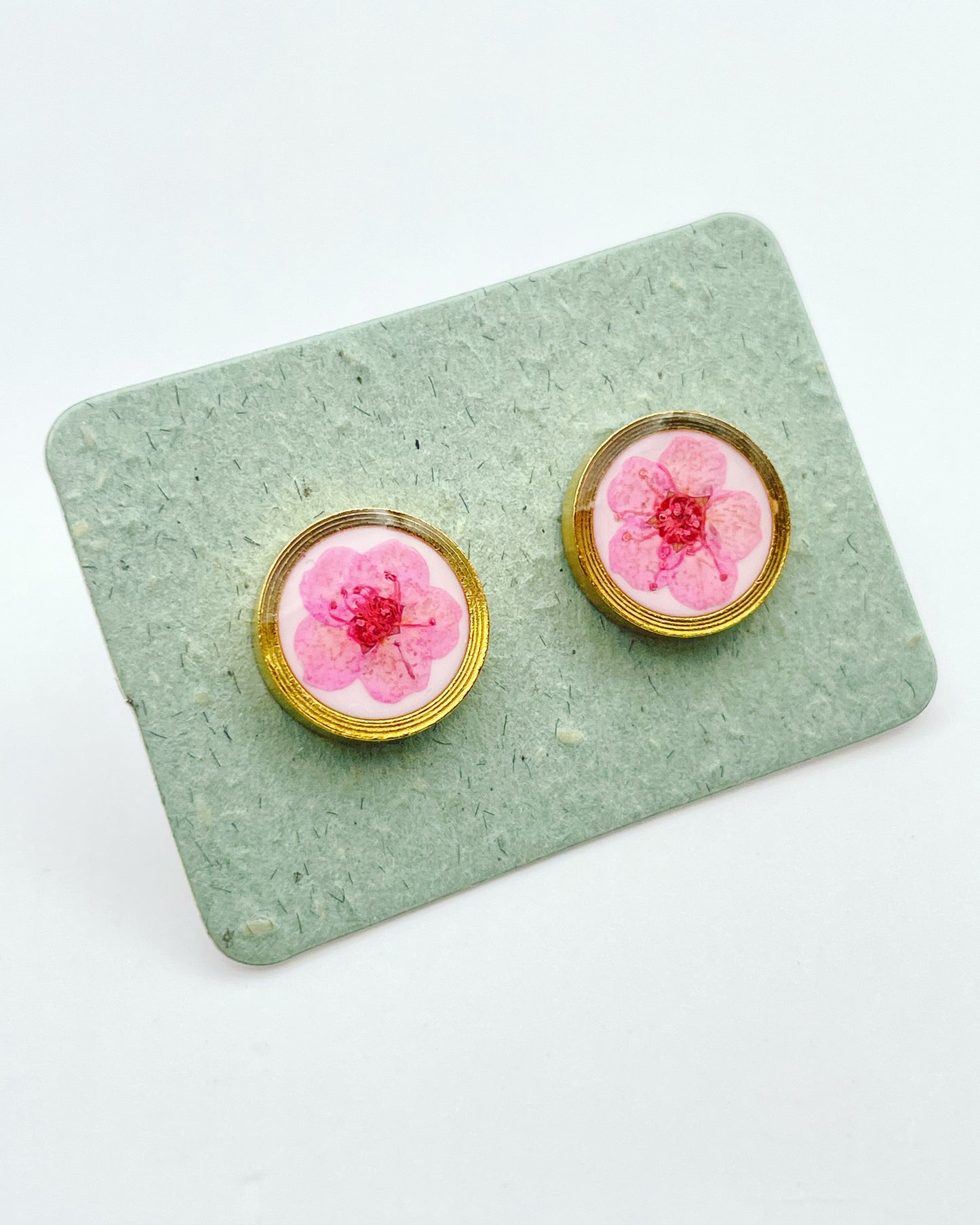 Stud earrings with pink flowers in white lacquer