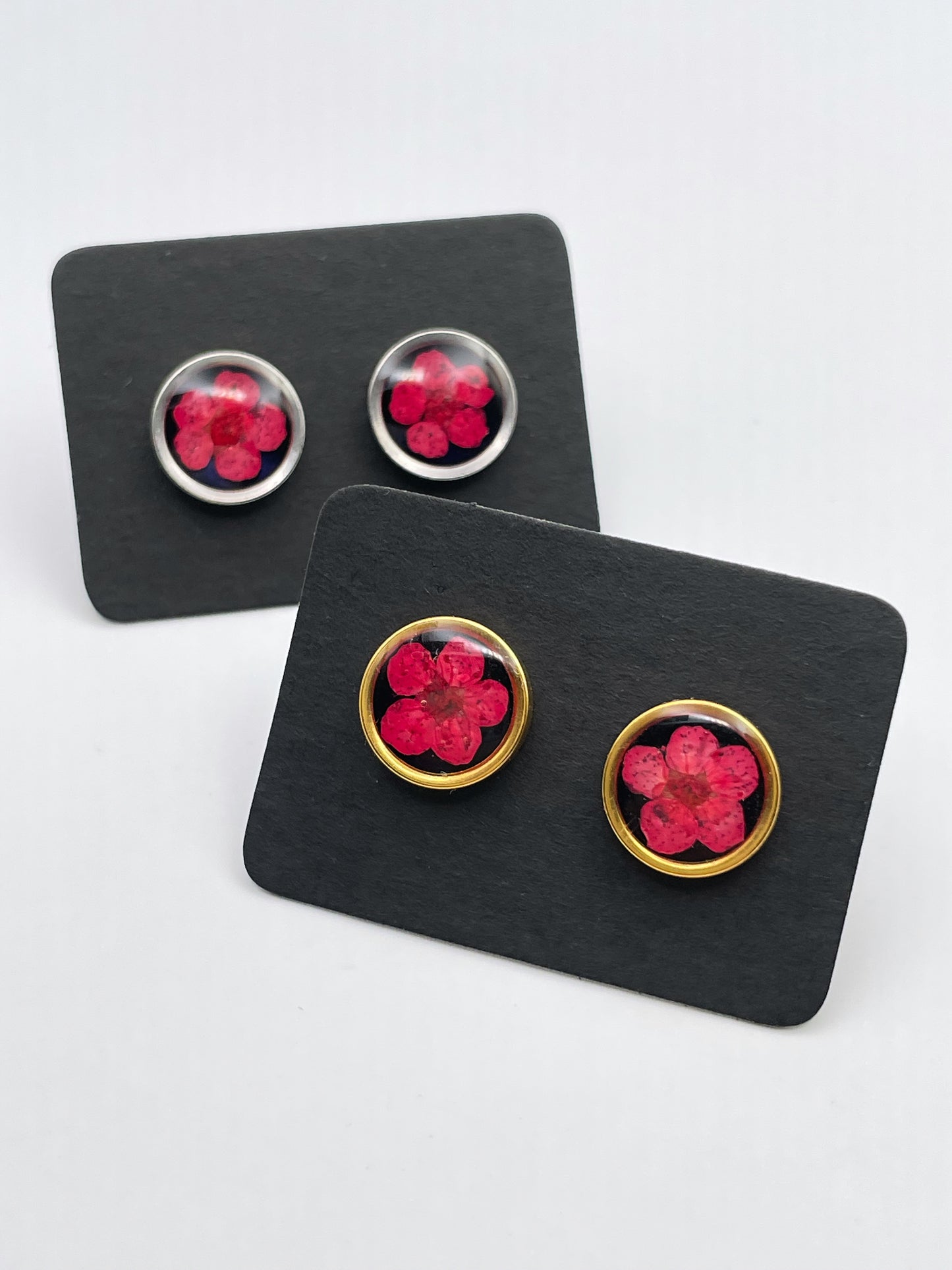 Stud earrings with red flowers in black lacquer