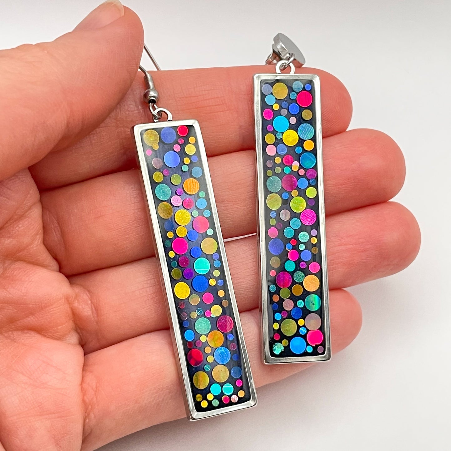 Long disco earrings with colourful sparkles in black lacquer