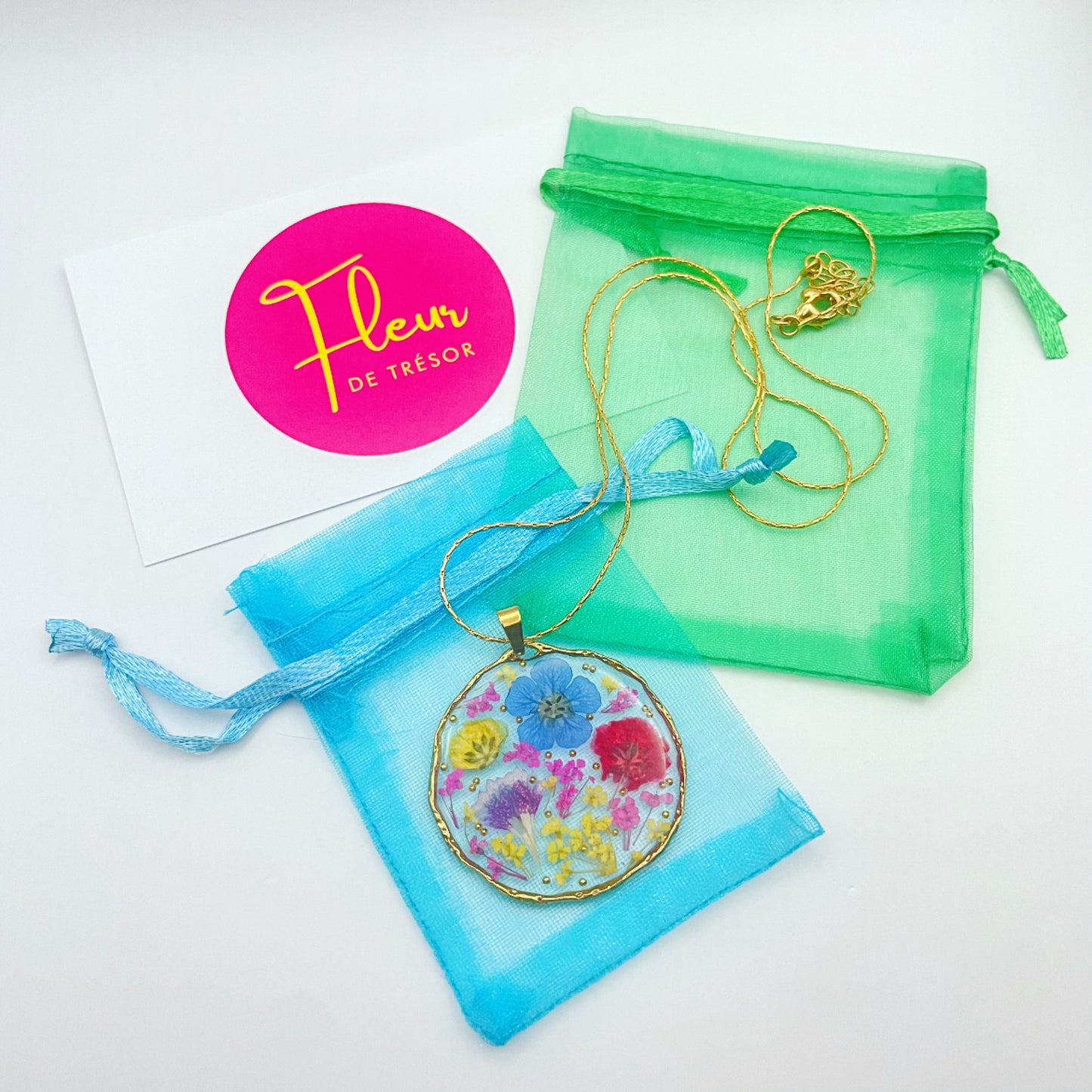 Pendant necklace with purple and blue flowers