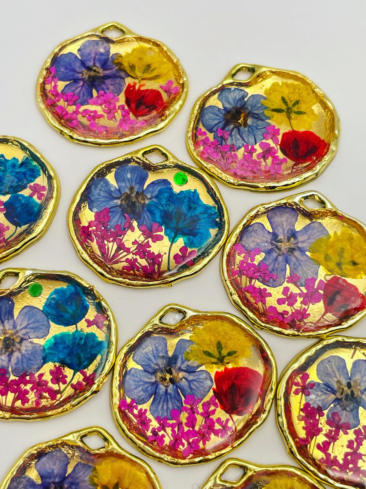 Gold pendant necklace with red and blue flowers