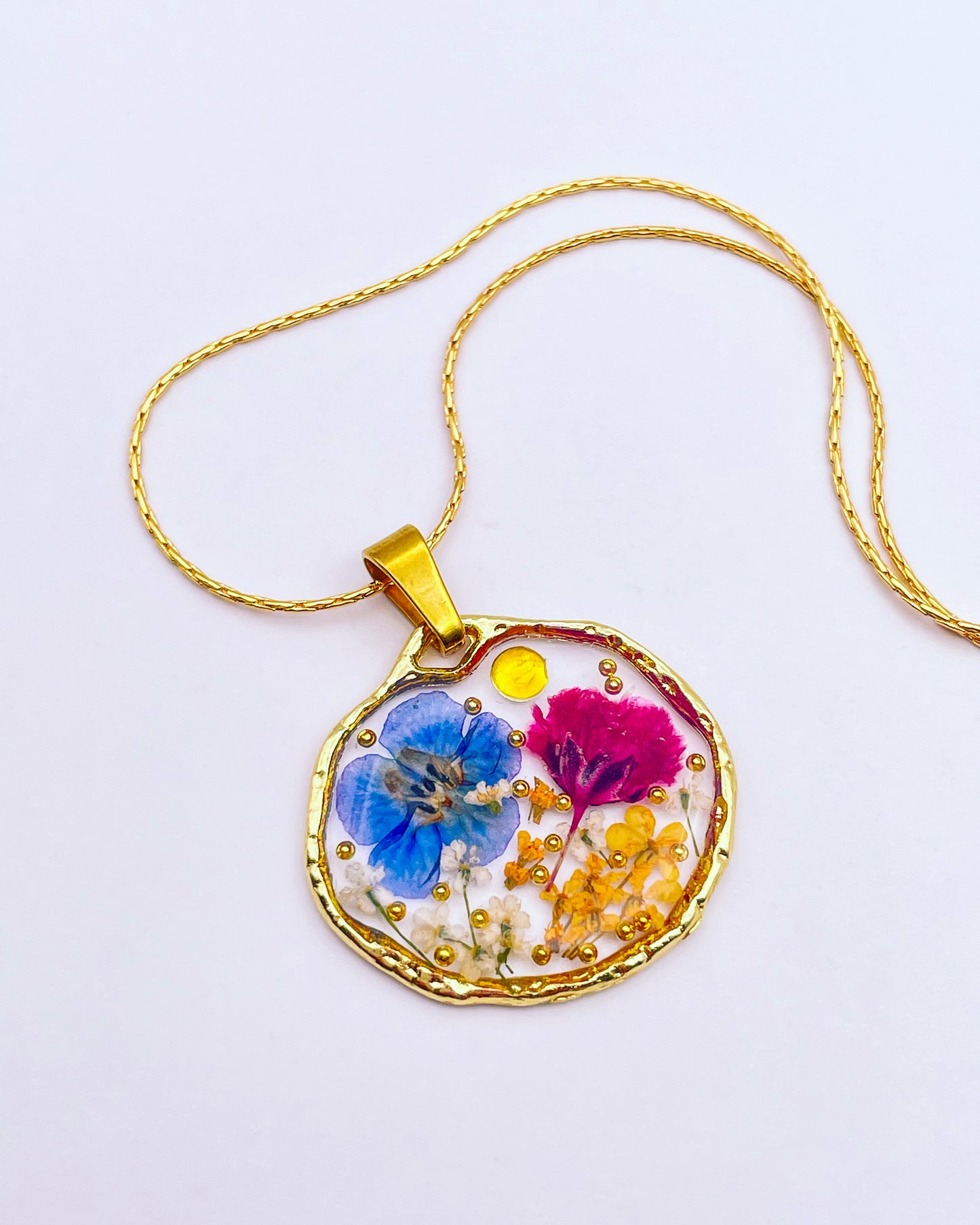 Pendant necklace with purple and blue flowers