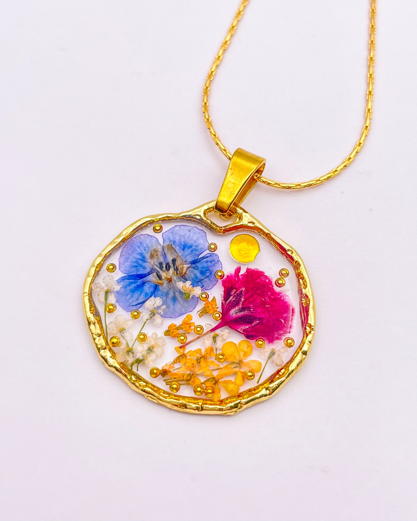 Pendant necklace with purple and blue flowers
