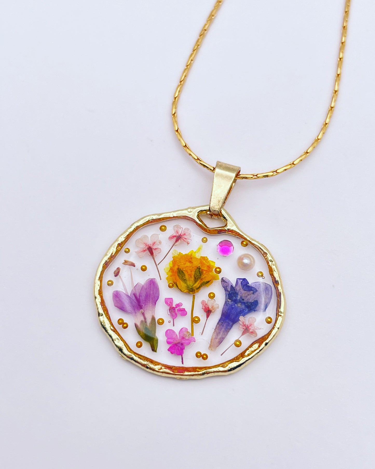 Pendant necklace with lavender and pink flowers