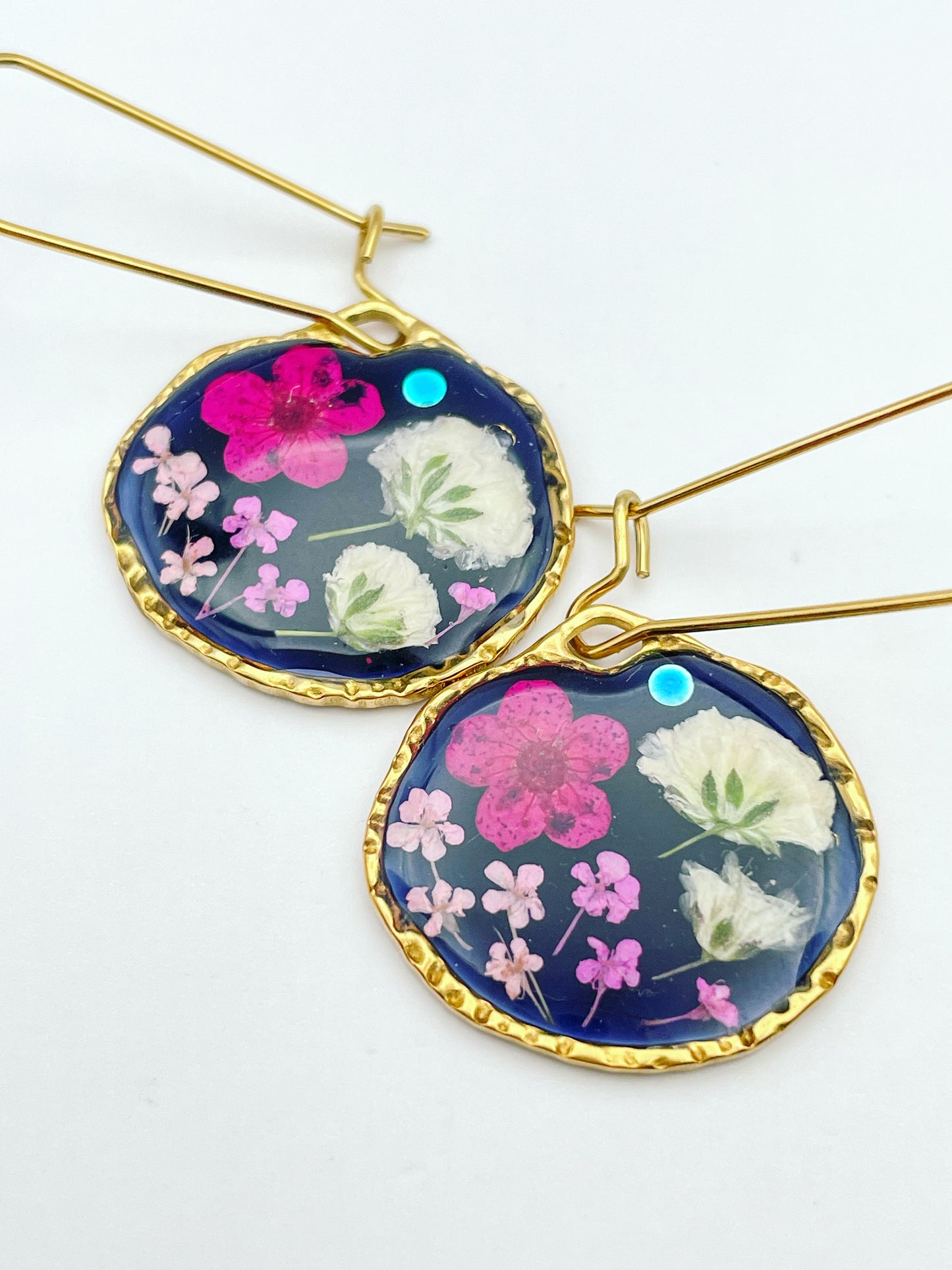 Black dangle earrings with pink and white flowers