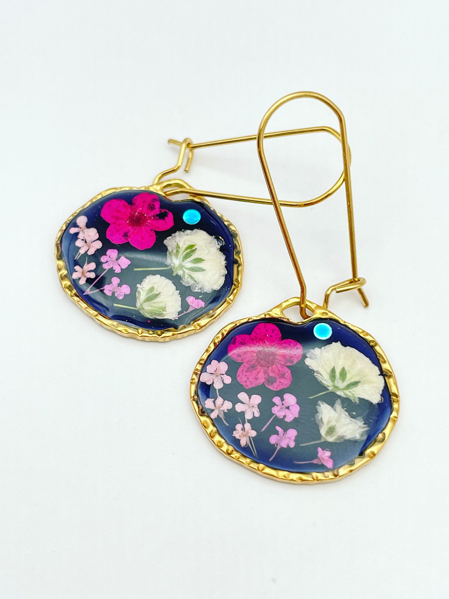 Black dangle earrings with pink and white flowers