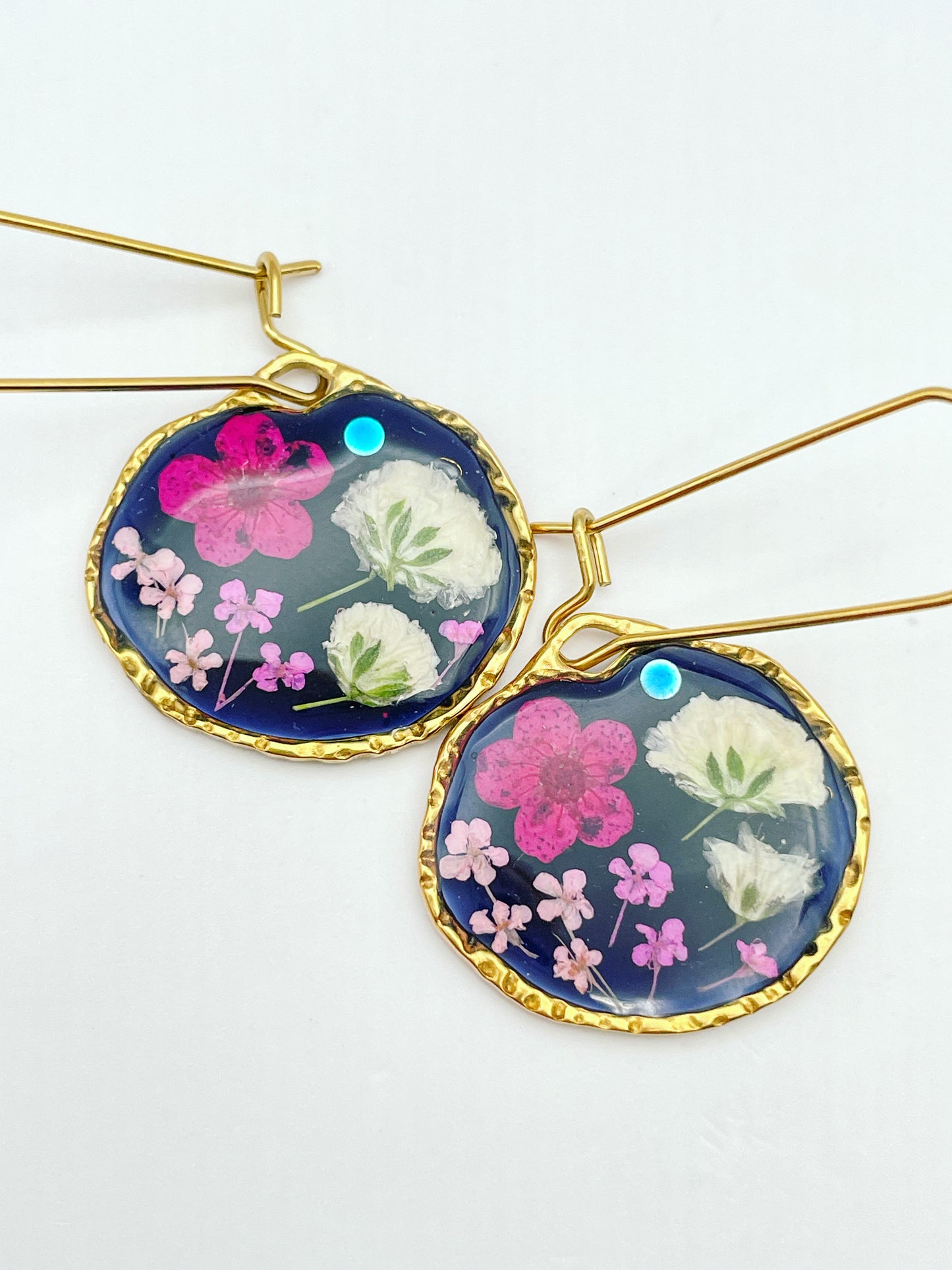 Black dangle earrings with pink and white flowers