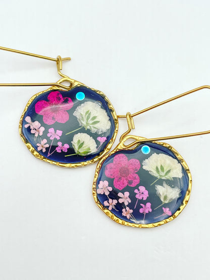 Black dangle earrings with pink and white flowers