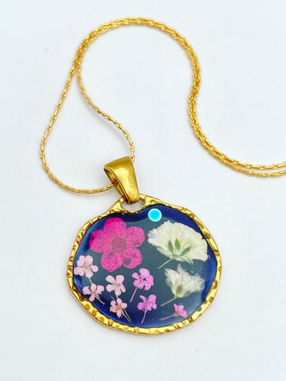 Black dangle earrings with pink and white flowers