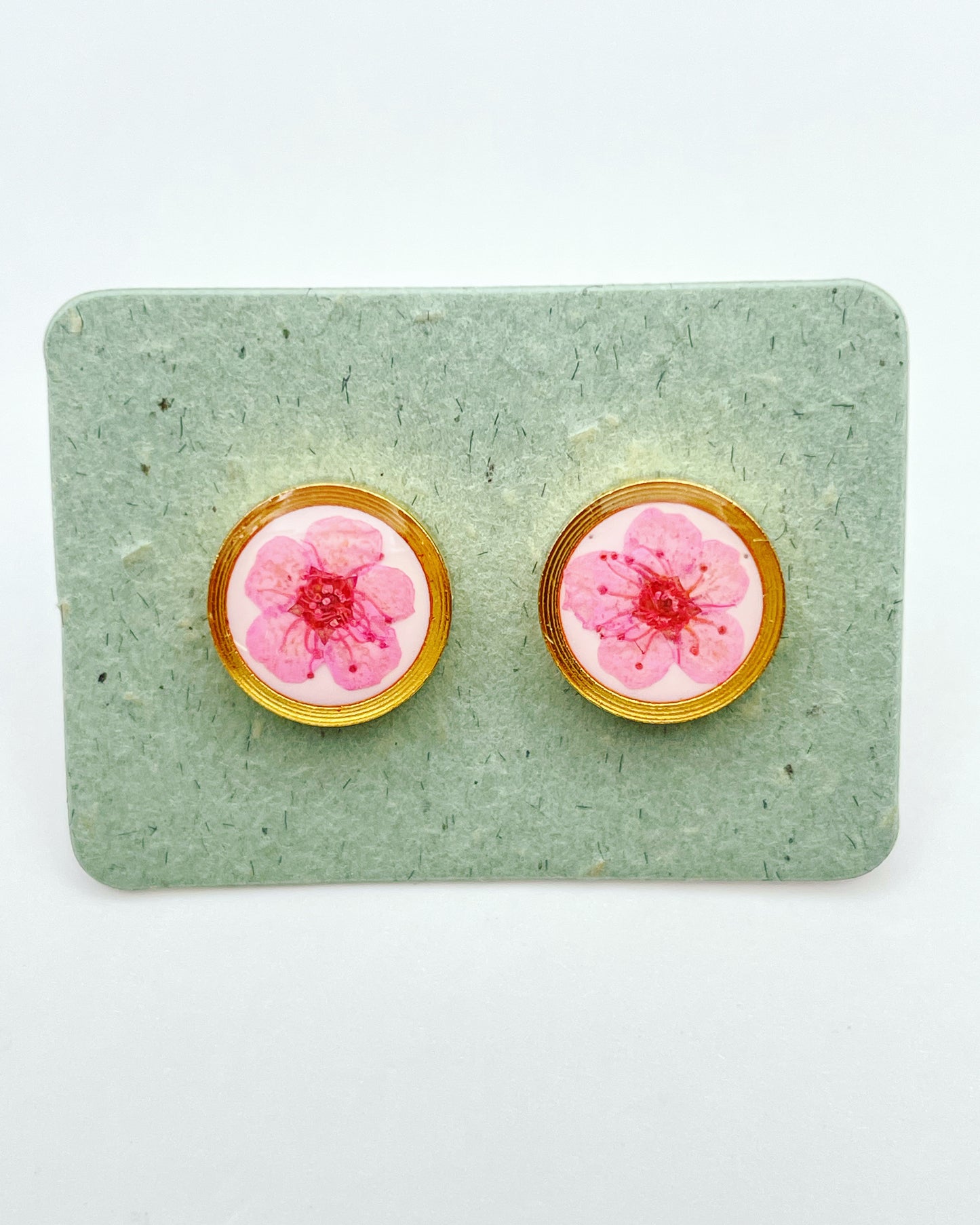 Stud earrings with pink flowers in white lacquer