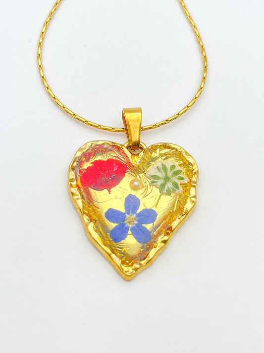 Gold heart necklace with poppy and forget-me-not flowers