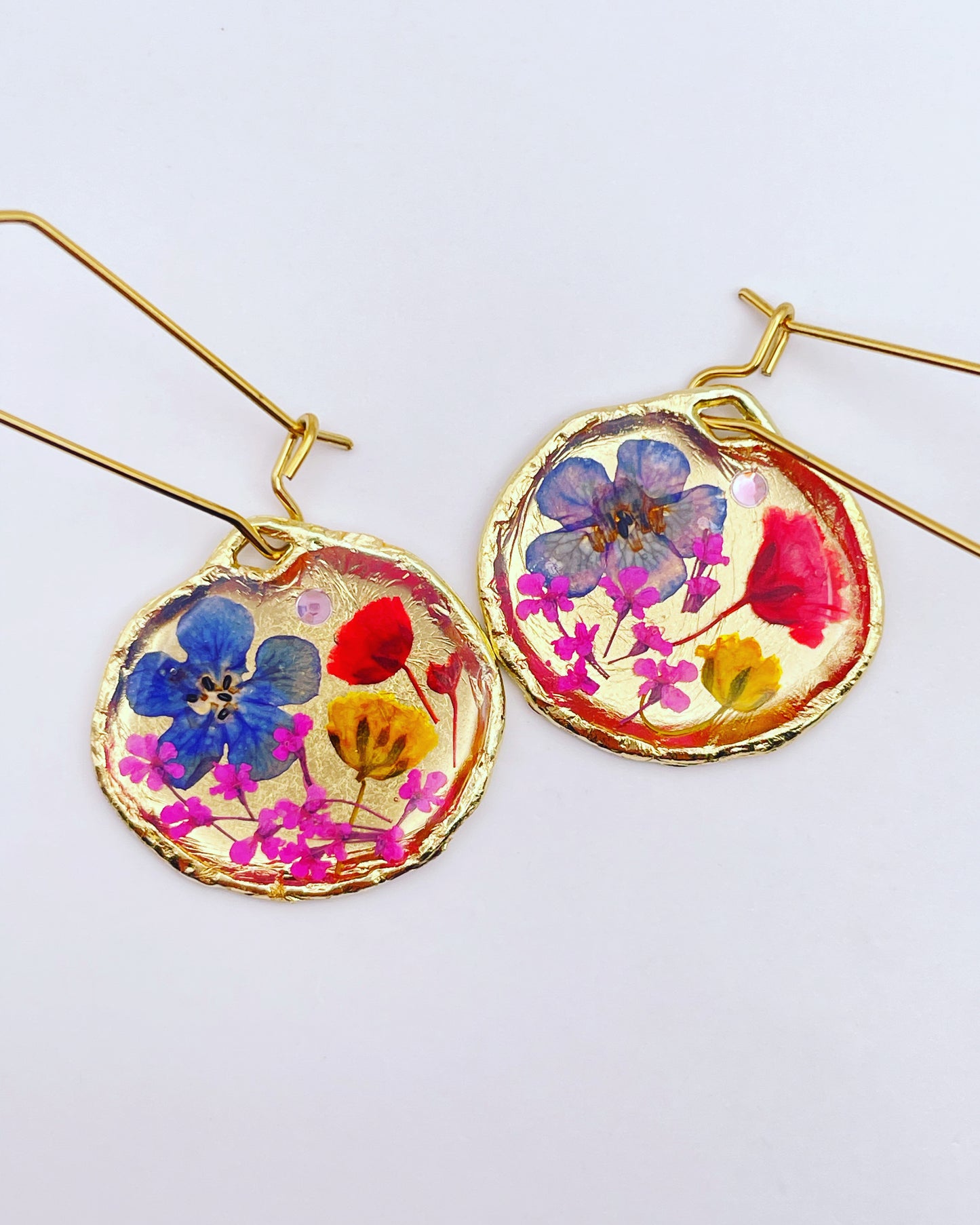 Gold dangle earrings with red and blue flowers