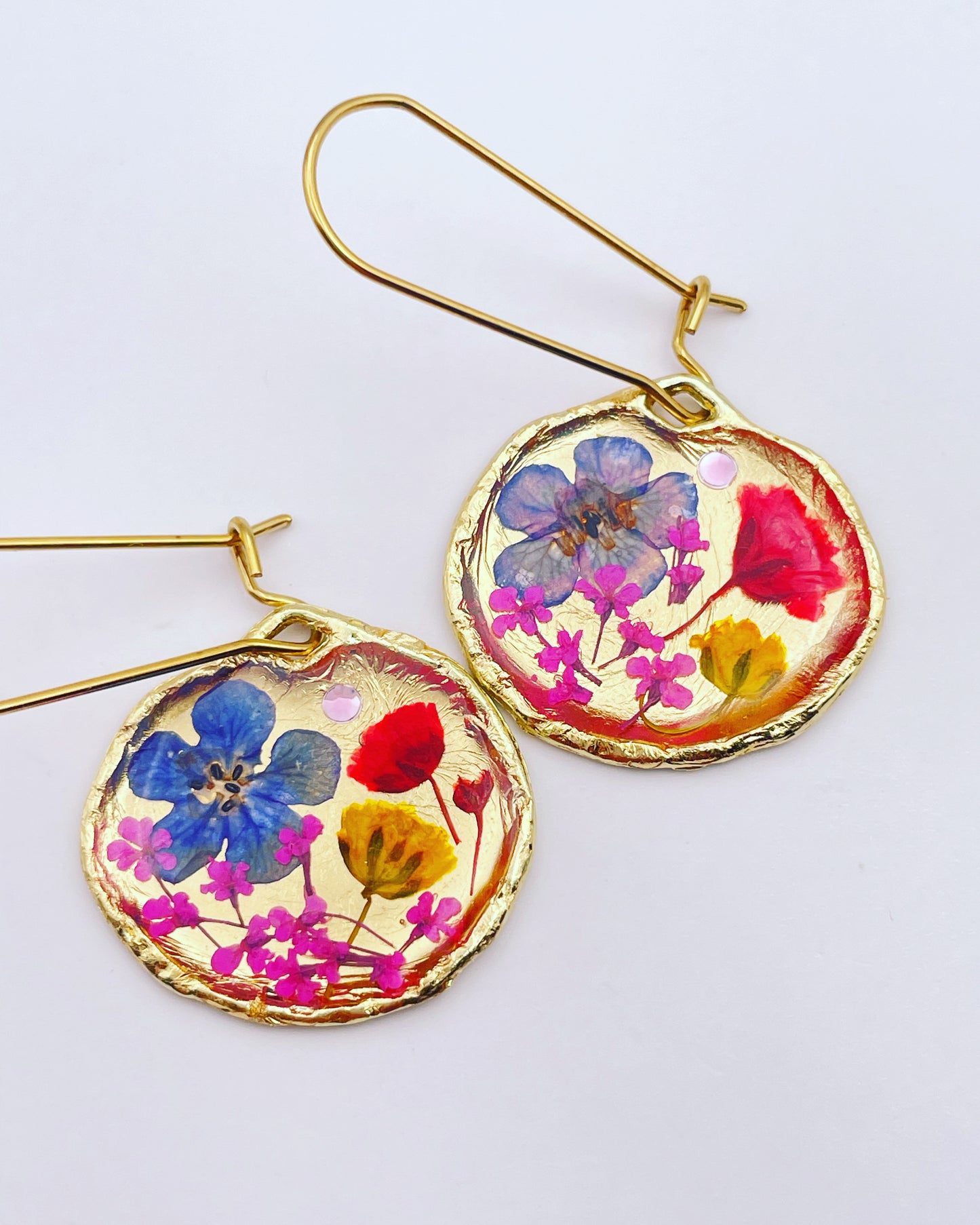 Gold dangle earrings with red and blue flowers