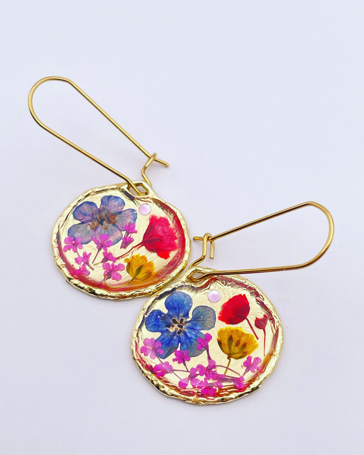 Gold dangle earrings with red and blue flowers