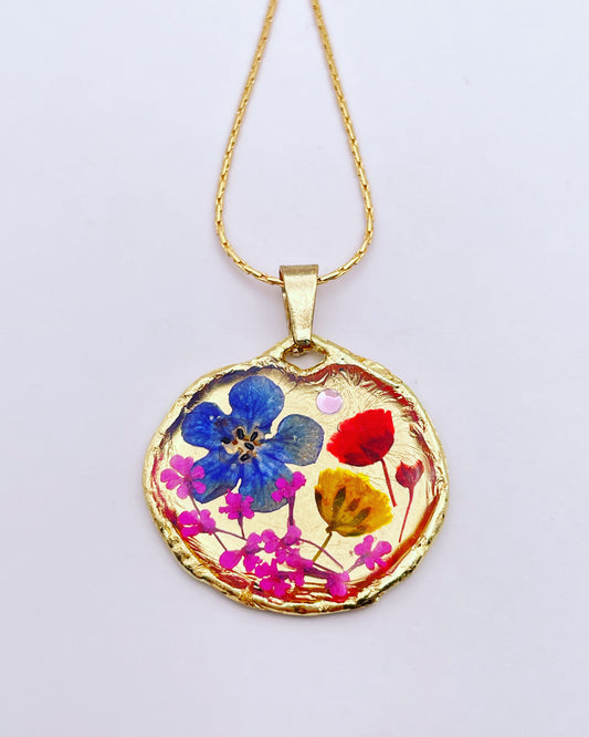Gold pendant necklace with red and blue flowers
