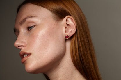 Stud earrings with red flowers in black lacquer