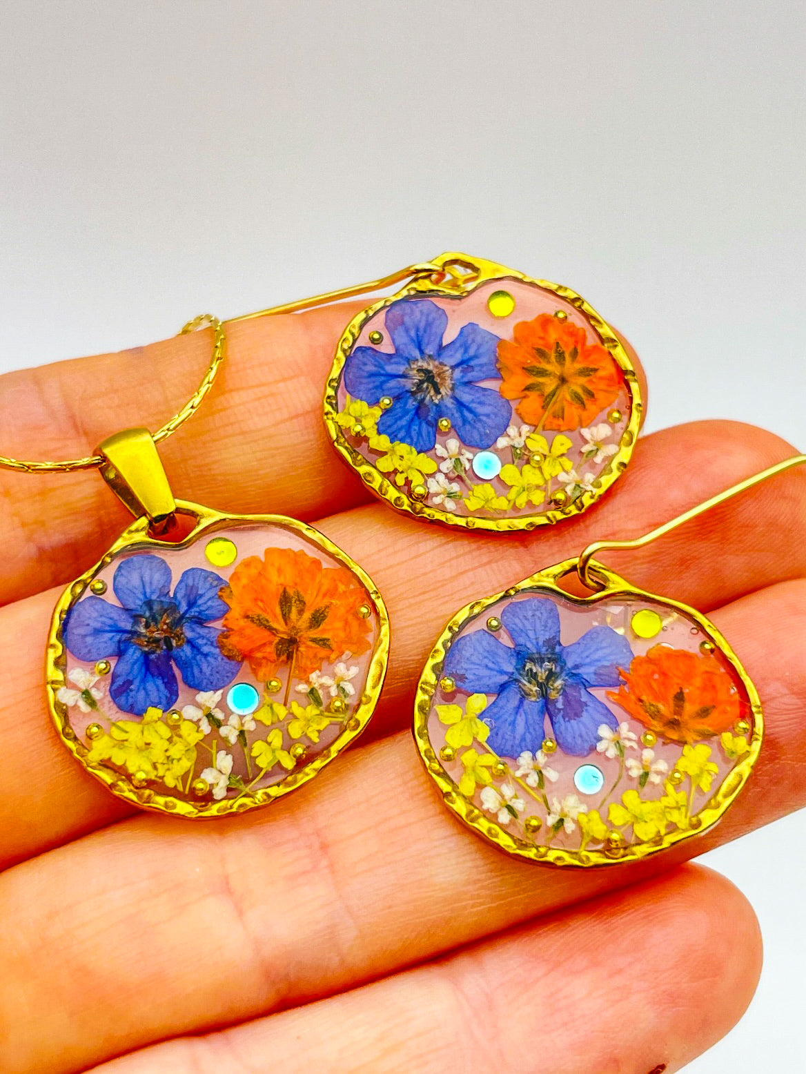 Anhänger-Halskette mit orangefarbenen und blauen Blumen