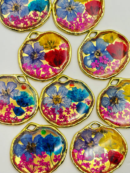 Gold pendant necklace with pink and blue flowers
