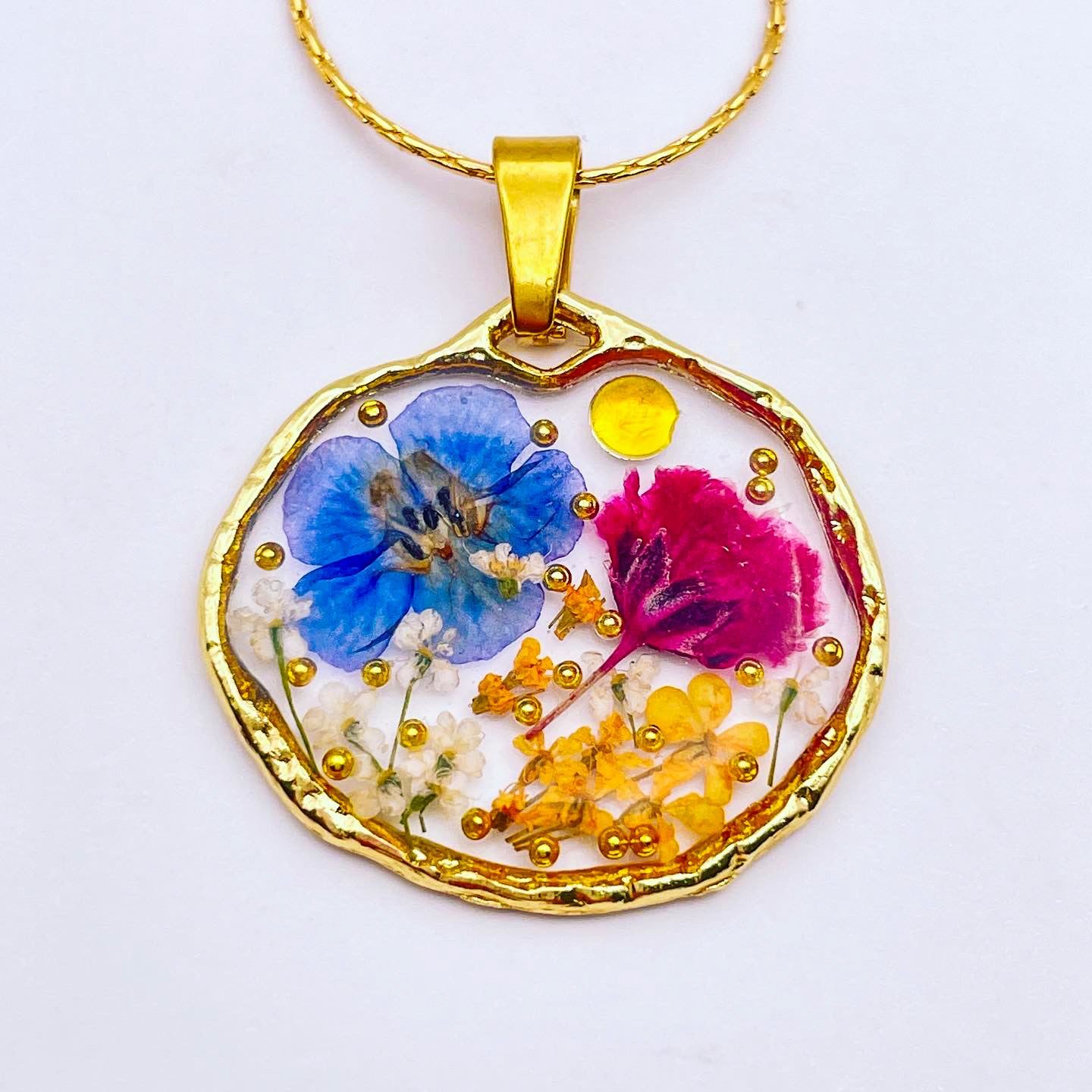 Pendant necklace with purple and blue flowers